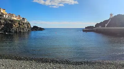 a body of water next to a rocky beach at Jose & Idalina House in Funchal