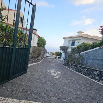 a gate leading to a driveway in a house at Jose & Idalina House in Funchal