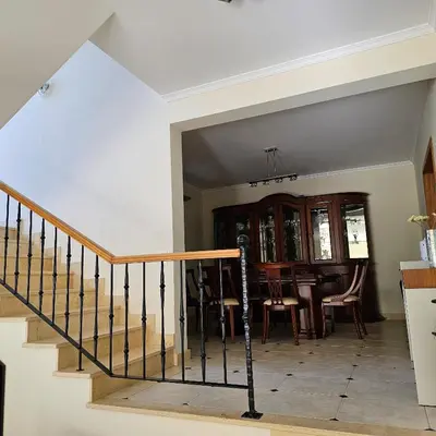 a dining room and kitchen with a staircase and a dining table at Jose & Idalina House in Funchal