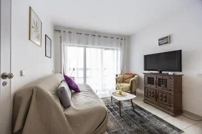 a living room with a couch and a tv at CoolHouses Algarve Luz, Sunny Luz in Luz