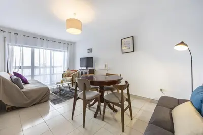 a living room with a table and a couch at CoolHouses Algarve Luz, Sunny Luz in Luz