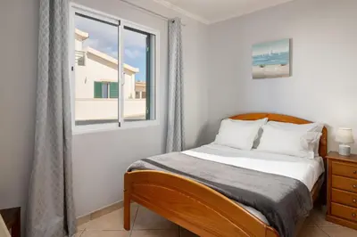 a bedroom with a bed and a window at Gazela House Comfort & Barbecue in Porto Santo in Porto Santo