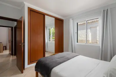a bedroom with a bed and a window at Gazela House Comfort & Barbecue in Porto Santo in Porto Santo