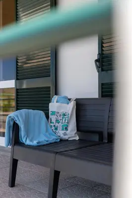 a bench with two bags sitting on top of it at Gazela House Comfort & Barbecue in Porto Santo in Porto Santo