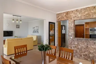 a living room and dining room with a table and chairs at Gazela House Comfort & Barbecue in Porto Santo in Porto Santo