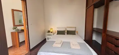 a bedroom with a bed with two towels on it at Casa do Juvenal in Funchal