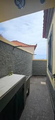 a patio of a house with a wall and a window at Casa do Juvenal in Funchal