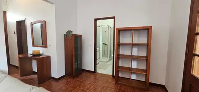 a room with shelves and a mirror and a bathroom at Casa do Juvenal in Funchal