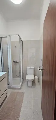 a bathroom with a white toilet and a shower at Casa do Juvenal in Funchal