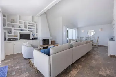 a bedroom with a bed with a view of the ocean at Casa Maresia da Salema in Salema