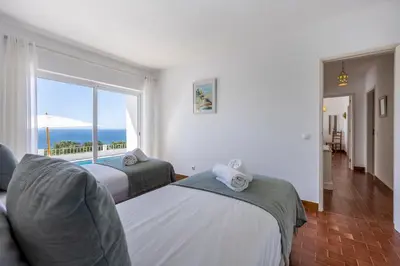 a living room with a couch and a tv at Casa Maresia da Salema in Salema