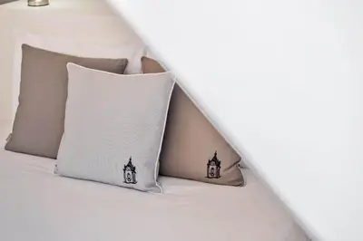 two pillows sitting on top of a bed at Nati by KAAMAH in Ribeira Brava