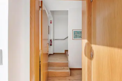 a hallway with a wooden door leading to a room at Nati by KAAMAH in Ribeira Brava