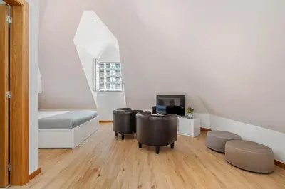 a room with two chairs and a bed and a tv at Nati by KAAMAH in Ribeira Brava