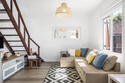a living room with a couch and a staircase at Blue House - By WehostMadeira in Ponta do Sol