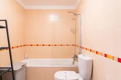 a bathroom with a toilet and a bath tub at GuestReady - Calm Haven in Madeira in Caniço
