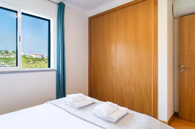 a bedroom with a bed with two towels on it at GuestReady - Calm Haven in Madeira in Caniço