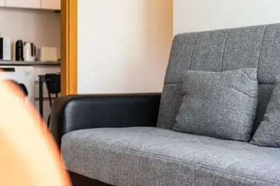 a gray couch with a gray pillow on it at GuestReady - Calm Haven in Madeira in Caniço