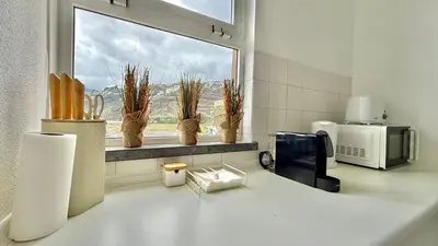 a kitchen with a counter with a microwave and a window at MaraHomes in Funchal