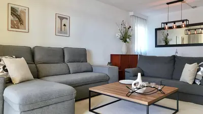 a living room with a couch and a table at MaraHomes in Funchal
