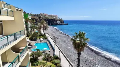 a view of the ocean from a balcony of a building at MaraHomes in Funchal