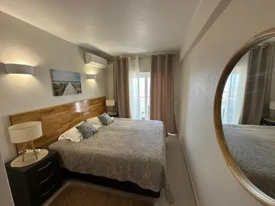 a hotel room with a bed and a mirror at Sunrise Luz Apartament in Luz