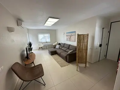 a living room with a couch and a table at Sunrise Luz Apartament in Luz