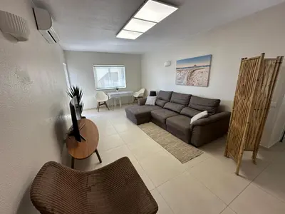 a living room with a couch and a table at Sunrise Luz Apartament in Luz
