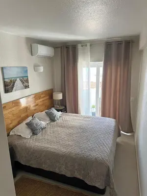 a bedroom with a large bed and a window at Sunrise Luz Apartament in Luz