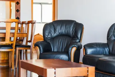 a living room with leather furniture and a table at GuestReady - Homely stay in Funchal in Funchal