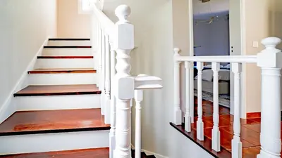 a staircase in a home with white railings at Family House in Campanário