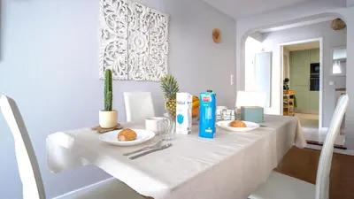 a white table with two plates of food on it at Family House in Campanário