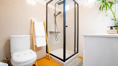 a bathroom with a shower and a toilet and a sink at Family House in Campanário