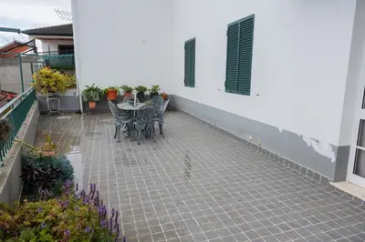 a patio with a table and chairs in a house at Bela AL in Funchal