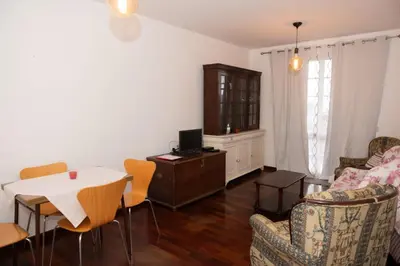 a living room with a table and chairs at Bela AL in Funchal