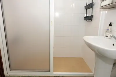 a bathroom with a shower and a sink at Bela AL in Funchal