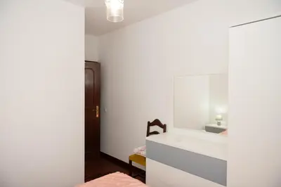 a bedroom with a white vanity and a mirror at Bela AL in Funchal