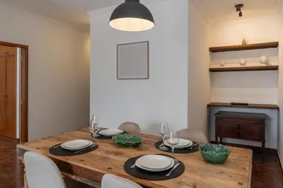 a dining room with a wooden table and chairs at Quebra Costas I by An Island Apart in Funchal