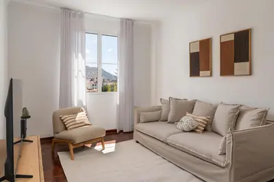 a living room with a couch and a chair at Quebra Costas I by An Island Apart in Funchal