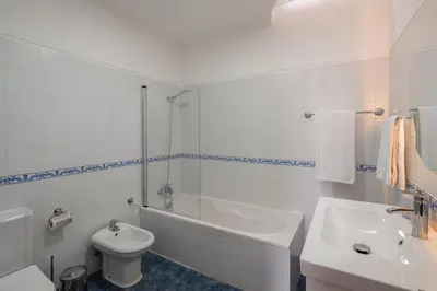 a bathroom with a tub and a toilet and a sink at Quebra Costas I by An Island Apart in Funchal