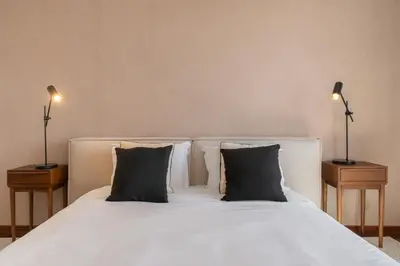 a bedroom with a white bed with two pillows at Quebra Costas I by An Island Apart in Funchal