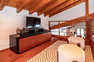 a living room with a television and two chairs at Quinta da Amoreira in Barão de São Miguel