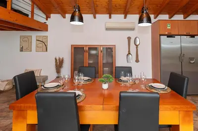 a dining room with a wooden table and chairs at Quinta da Amoreira in Barão de São Miguel