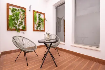 two chairs and a table in a room at Quinta da Amoreira in Barão de São Miguel
