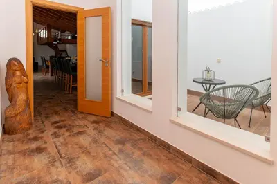 a hallway with a door and a table and chairs at Quinta da Amoreira in Barão de São Miguel