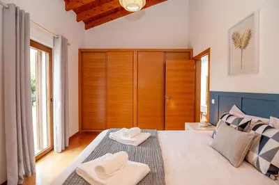 a bedroom with a large bed with two towels on it at Quinta da Amoreira in Barão de São Miguel
