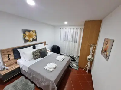 a bedroom with a large bed with two towels on it at Prazeres - Madeira Inn Group in Prazeres