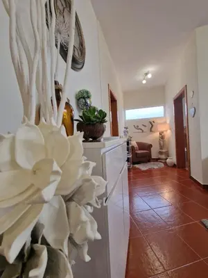 a living room with a large white flower sculpture at Prazeres - Madeira Inn Group in Prazeres