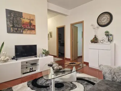 a living room with a tv and a glass table at Prazeres - Madeira Inn Group in Prazeres