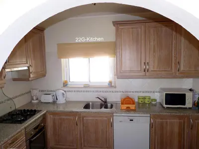 a kitchen with an archway over a sink and a microwave at Luz dream apartment 22G above beach in Luz